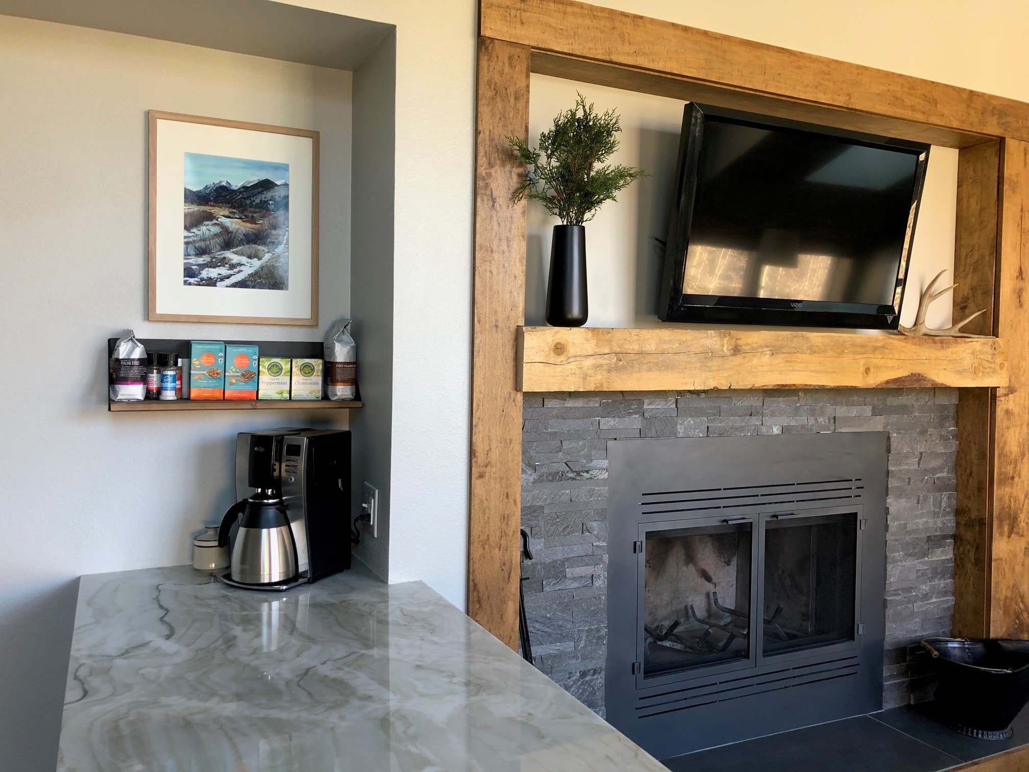 Norstone Charcoal Rock Panels surrounding fireplace with rough hewn wooden accents in Colorado mountain ski condo